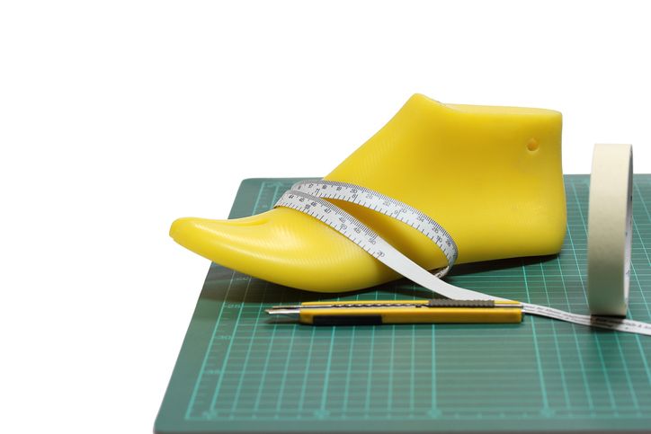 Last shoe and equipment used in shoe design on white background , focuses on the last shoe.