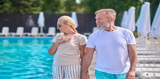 Swimming pool. A man and a woman walking along the