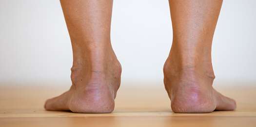 woman-bare-feet-on-the-floor-legs-care-and-skin